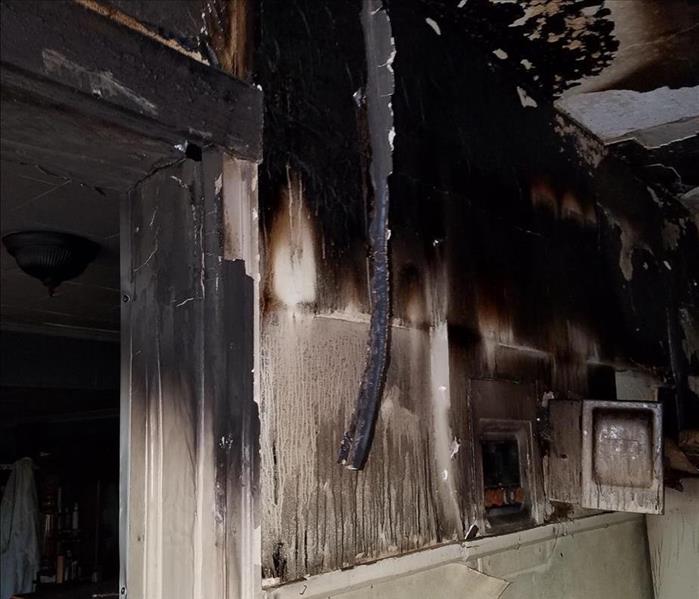 interior of a home covered in black soot and smoke