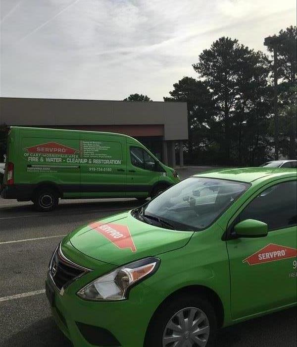 Two SERVPRO vehicles in a parking lot. 
