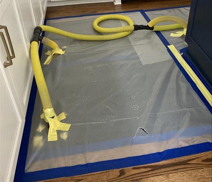 drying mats on wood flooring in a kitchen