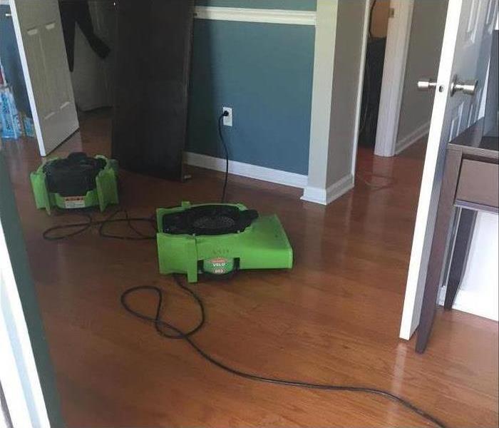 Two air movers placed on wooden floor. Drying equipment. Water cleanup concept