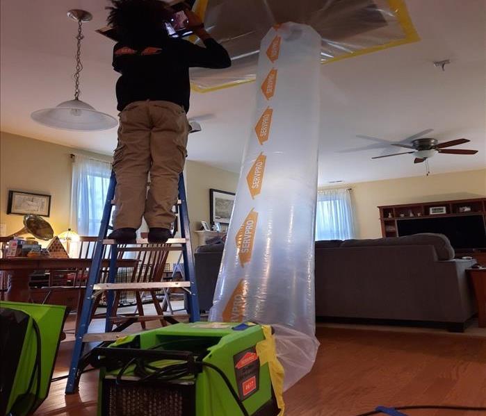 tech setting up flex for drying attic