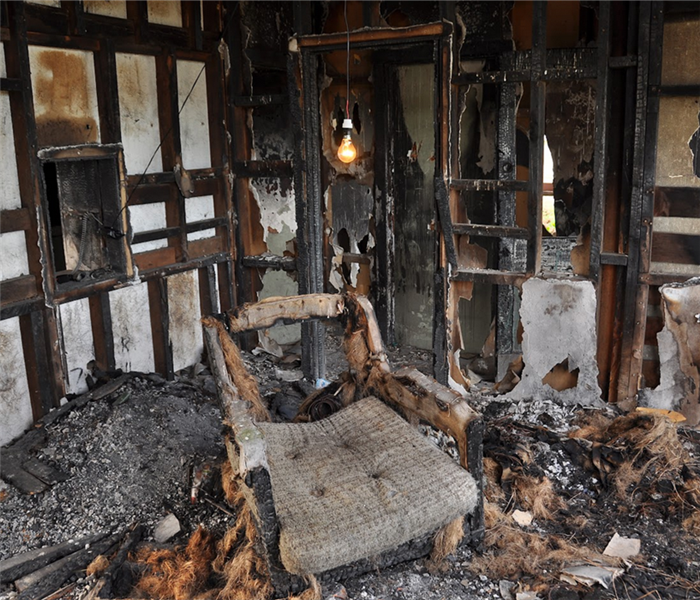 a fire damaged living room with debris covering the floor
